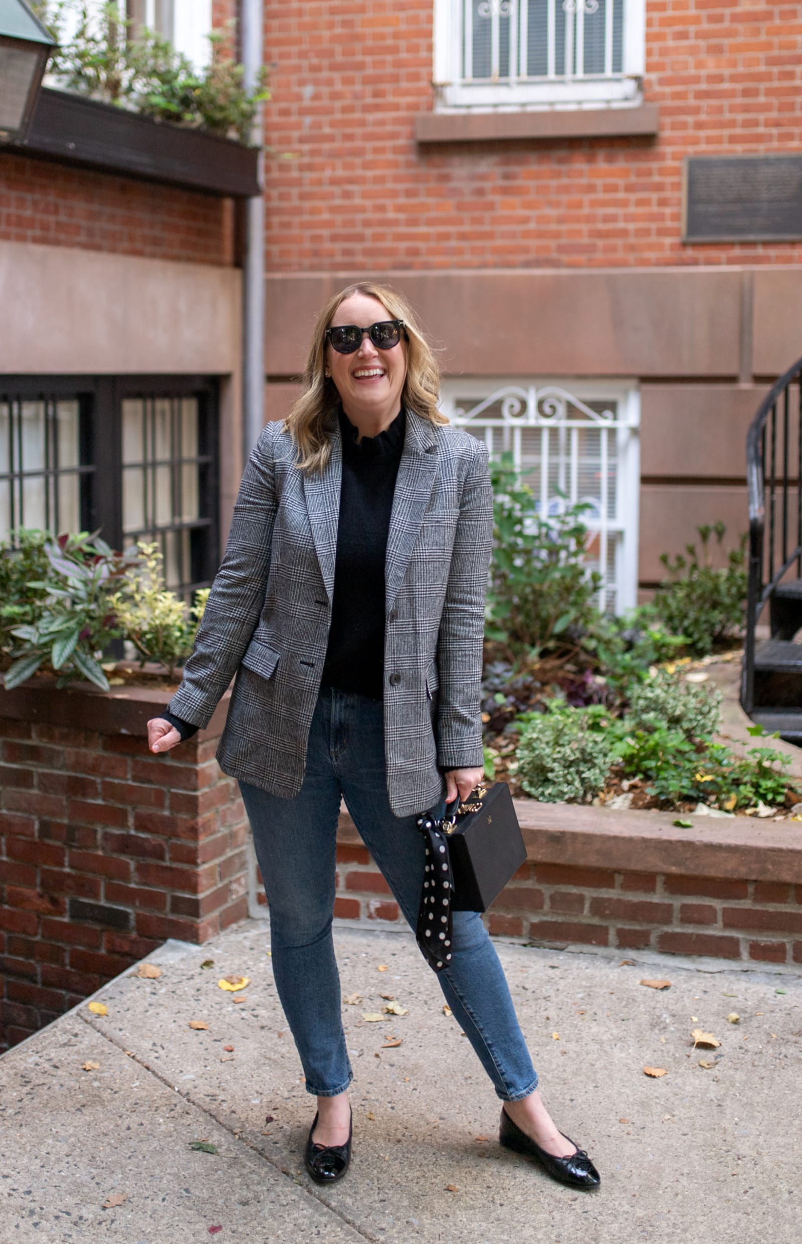 What to Wear to Paris in Winter Wit & Whimsy wearing a blazer, skinny jeans and ballet flats.