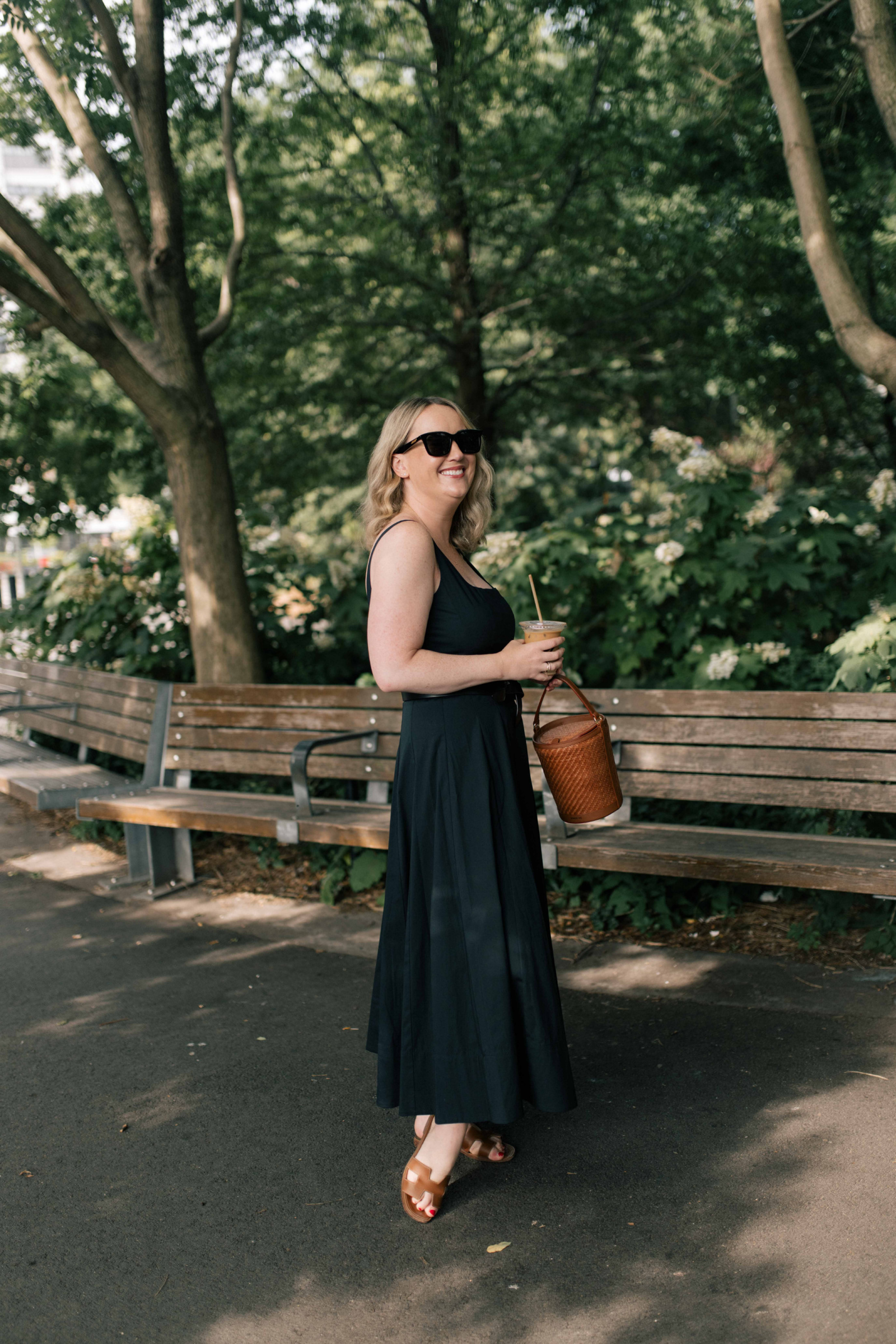 Wit Whimsy shares sandal styles worth buying - in photo: woman wearing H sandals and black dress