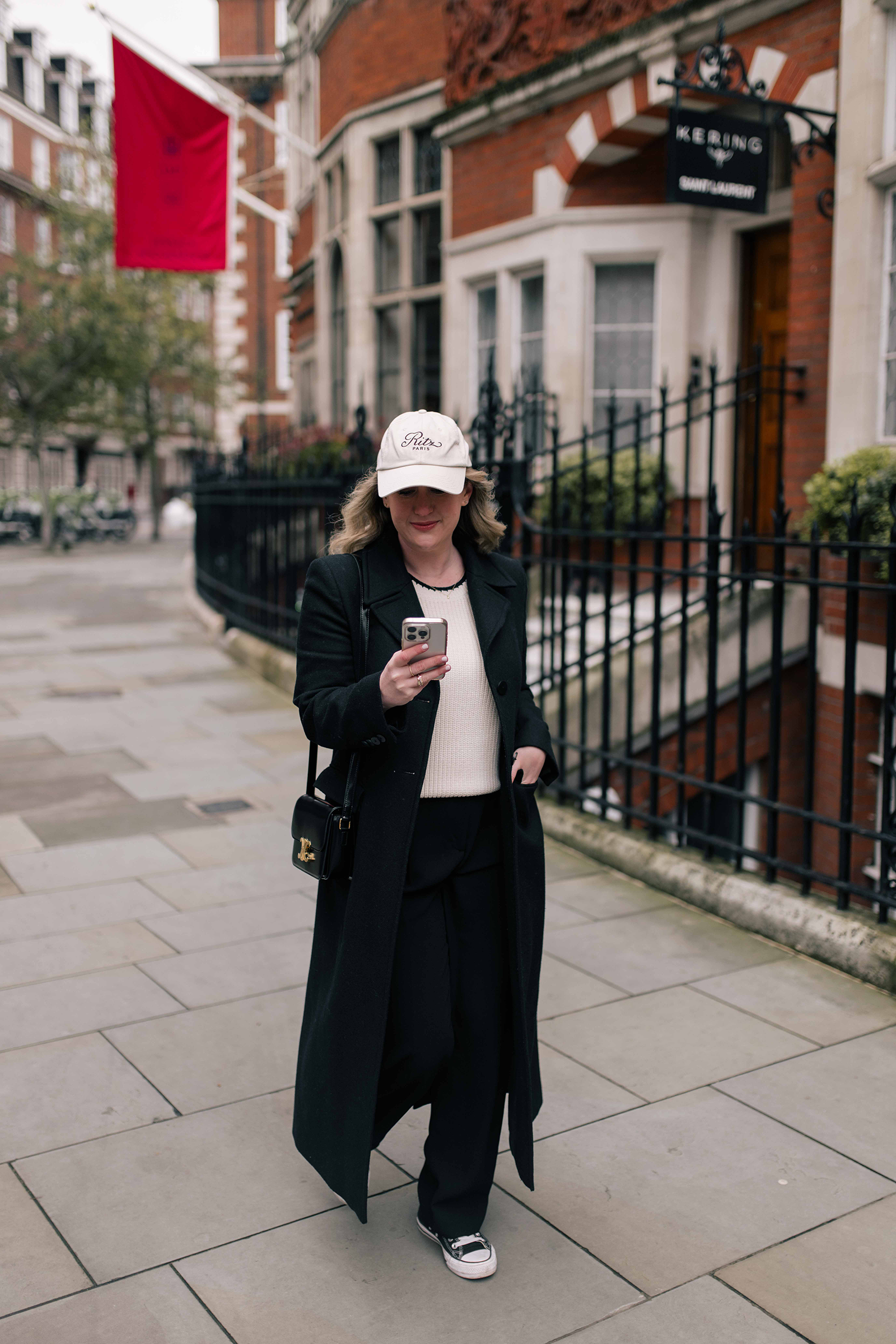 What to Pack for the Cotswolds Wit Whimsy wearing a baseball cap and straight leg jeans.