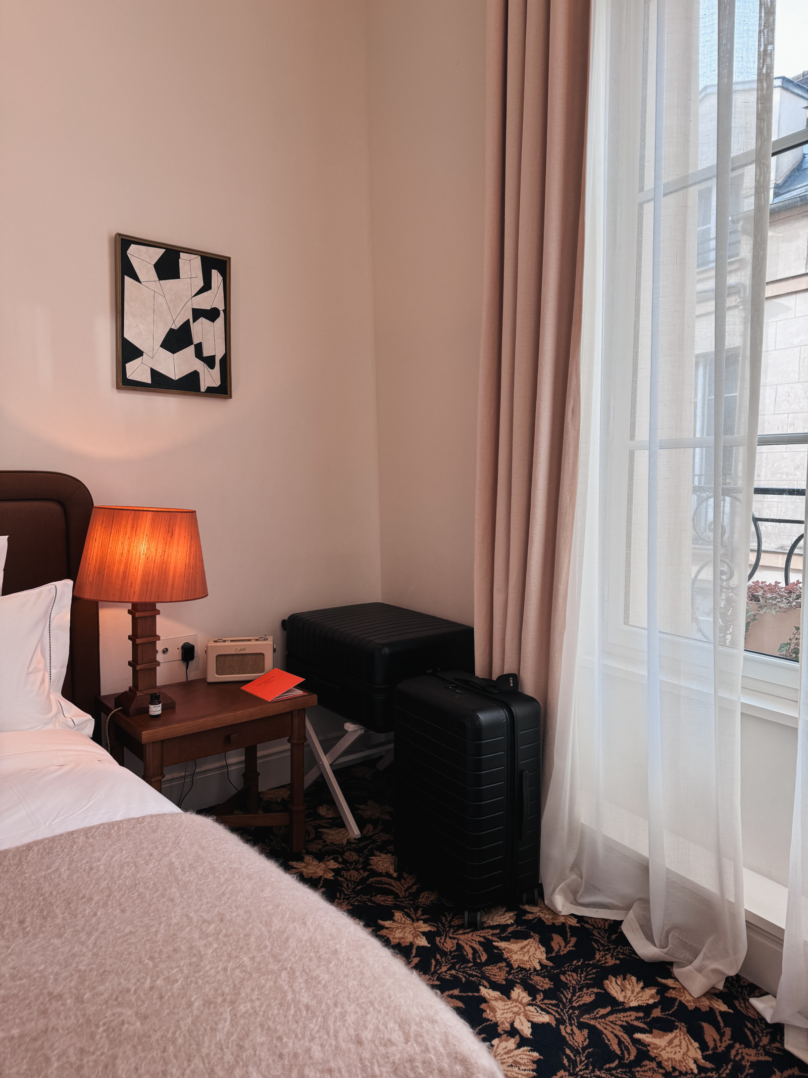 A suitcase placed on the floor of a hotel room