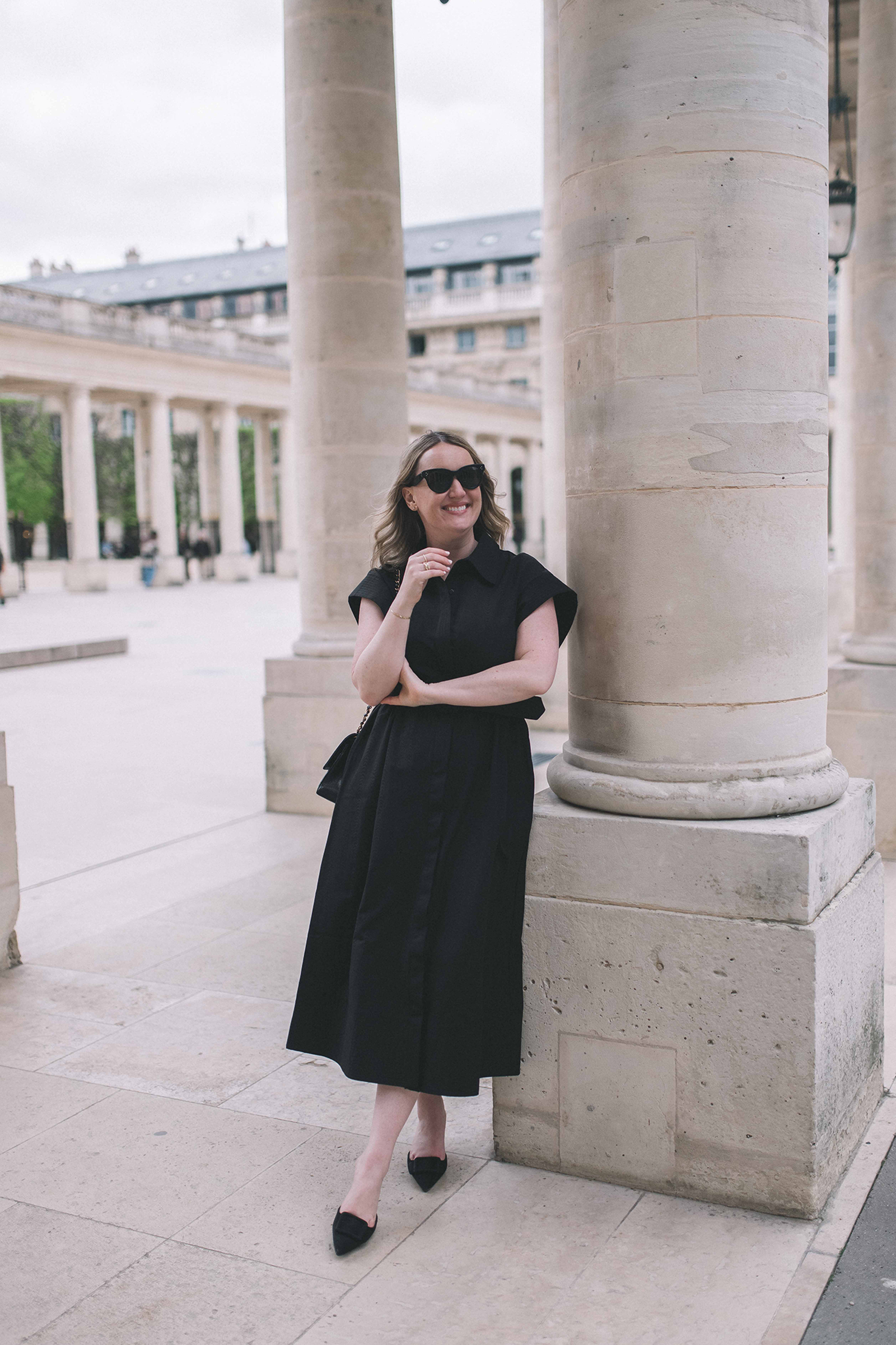 Wit Whimsy Blogger Meghan Donovan shares What to Wear in Paris in the Spring - in photo: Meghan wearing a black dress in Paris in spring