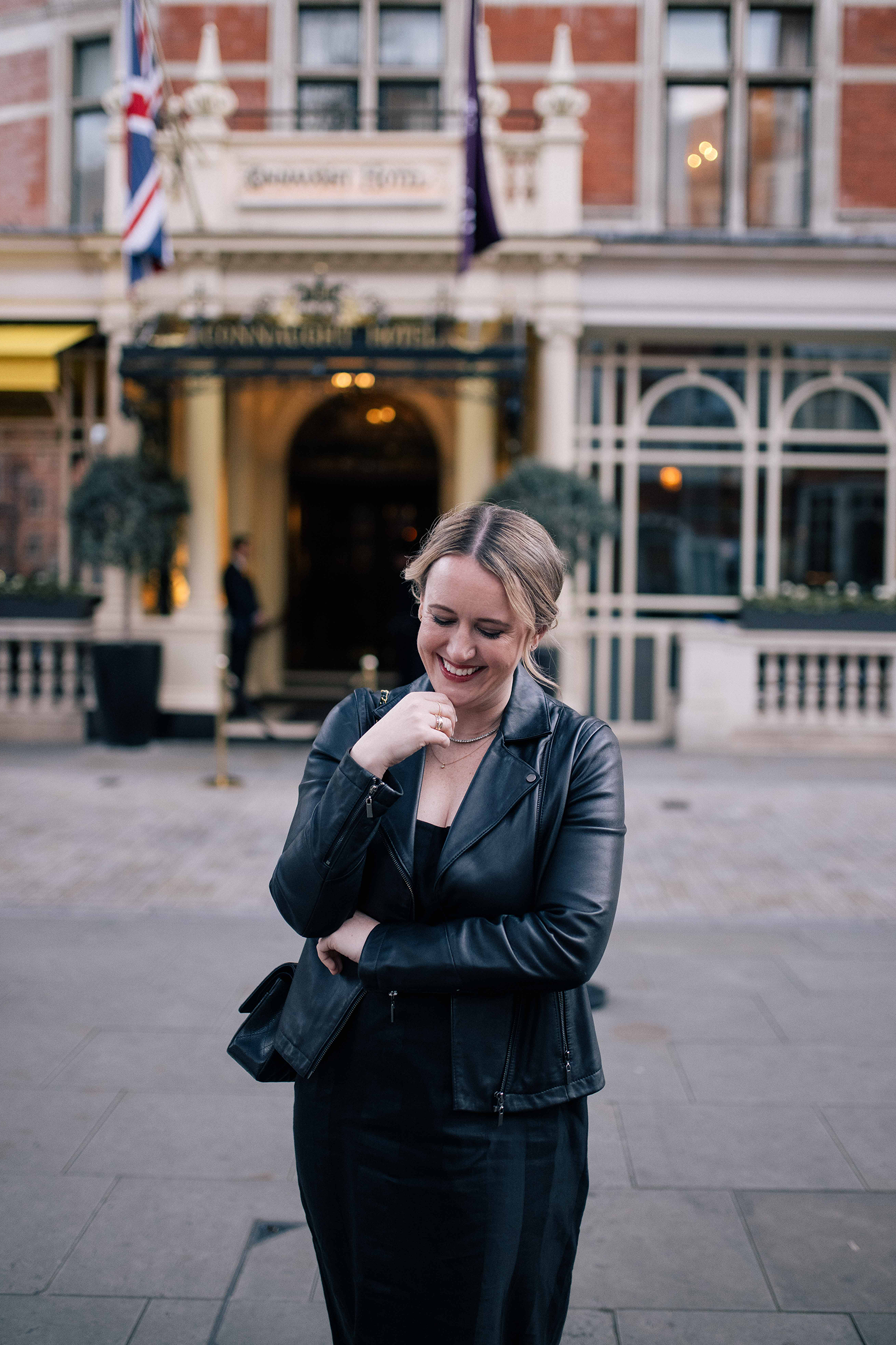 What to Wear in London Meghan wearing black dress and black leather jacket