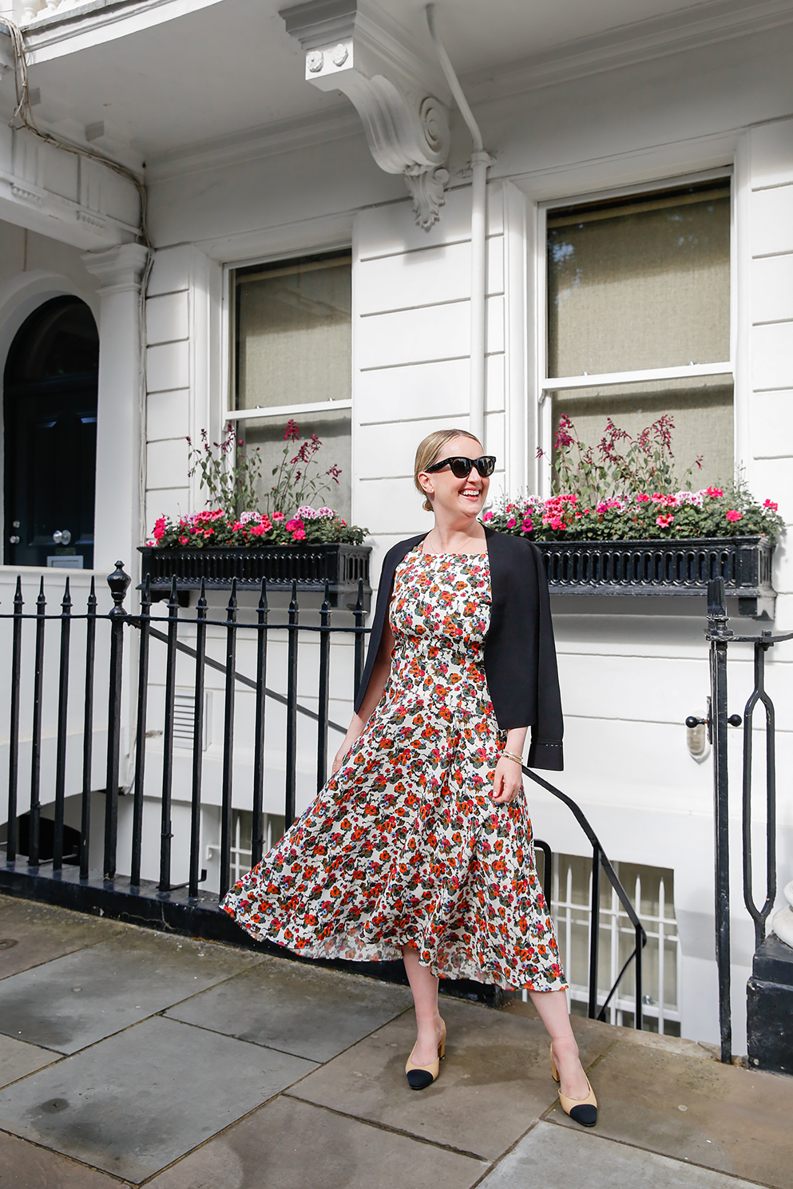 What to Wear in London Wit Whimsy Blogger Meghan Donovan shares What to Wear in London - in photo: Meghan wearing floral dress and black blazer