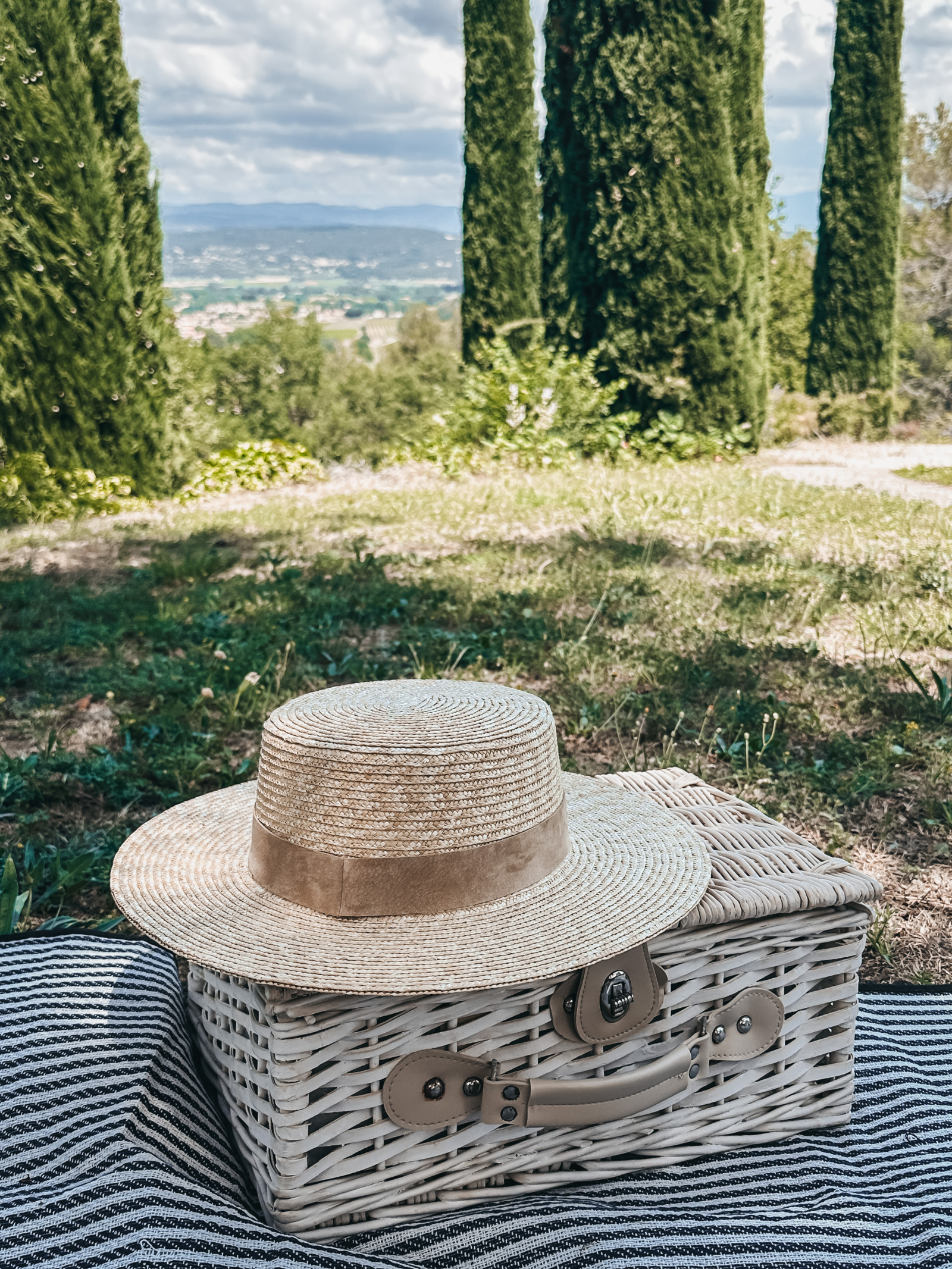 a classic straw boater hat with a beige velvet ribbon
