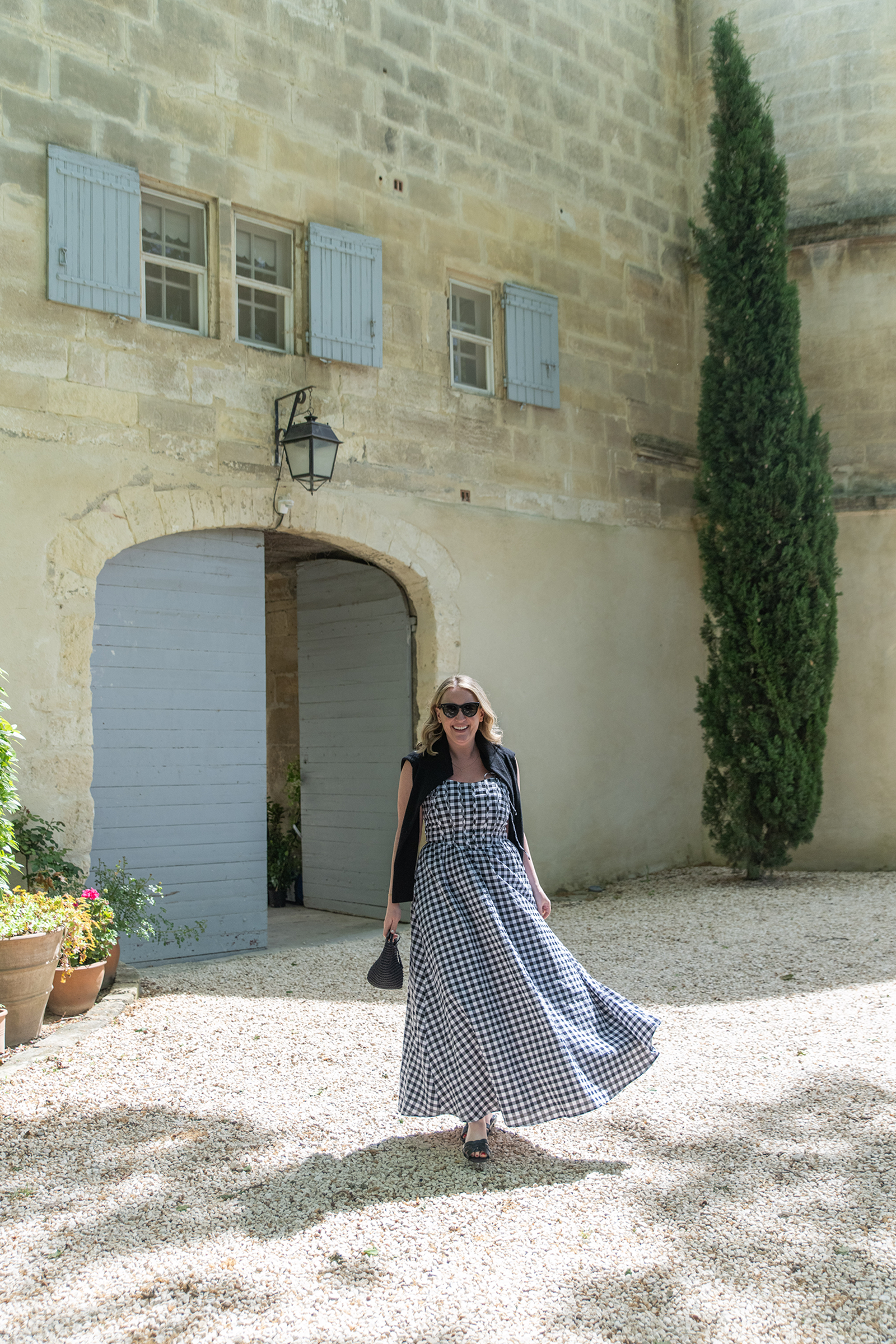 Meghan wearing a gingham dress in the south of france