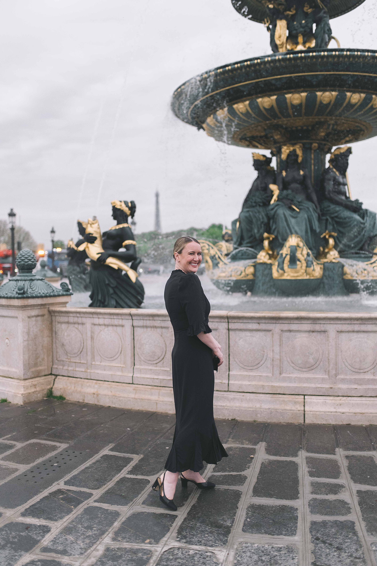 Woman in a black midi dress with Chanel slingback heels at Place de la Concorde in Paris, showing what shoes to wear with black dresses. Woman in a black midi dress with Chanel slingback heels at Place de la Concorde in Paris, showing what shoes to wear with black dresses.