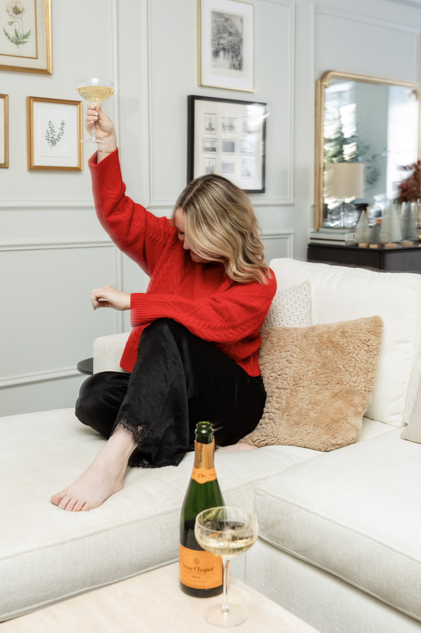 wit whimsy drinking a glass of champagne for the holiday season.