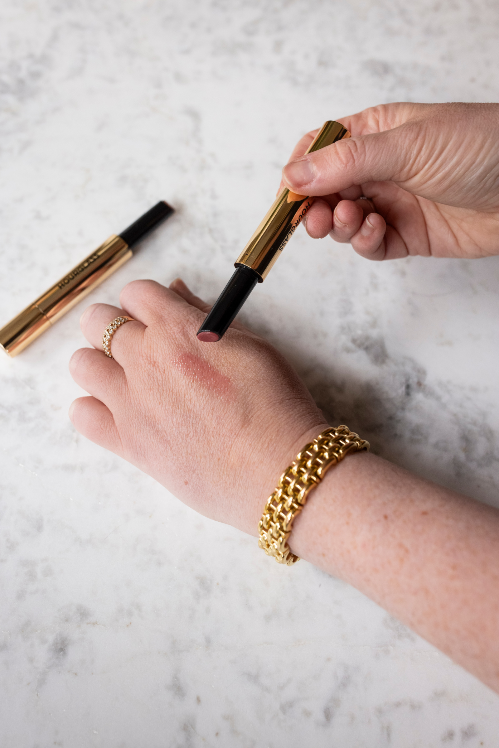 Wit Whimsy swatch Balms on the back of her hand