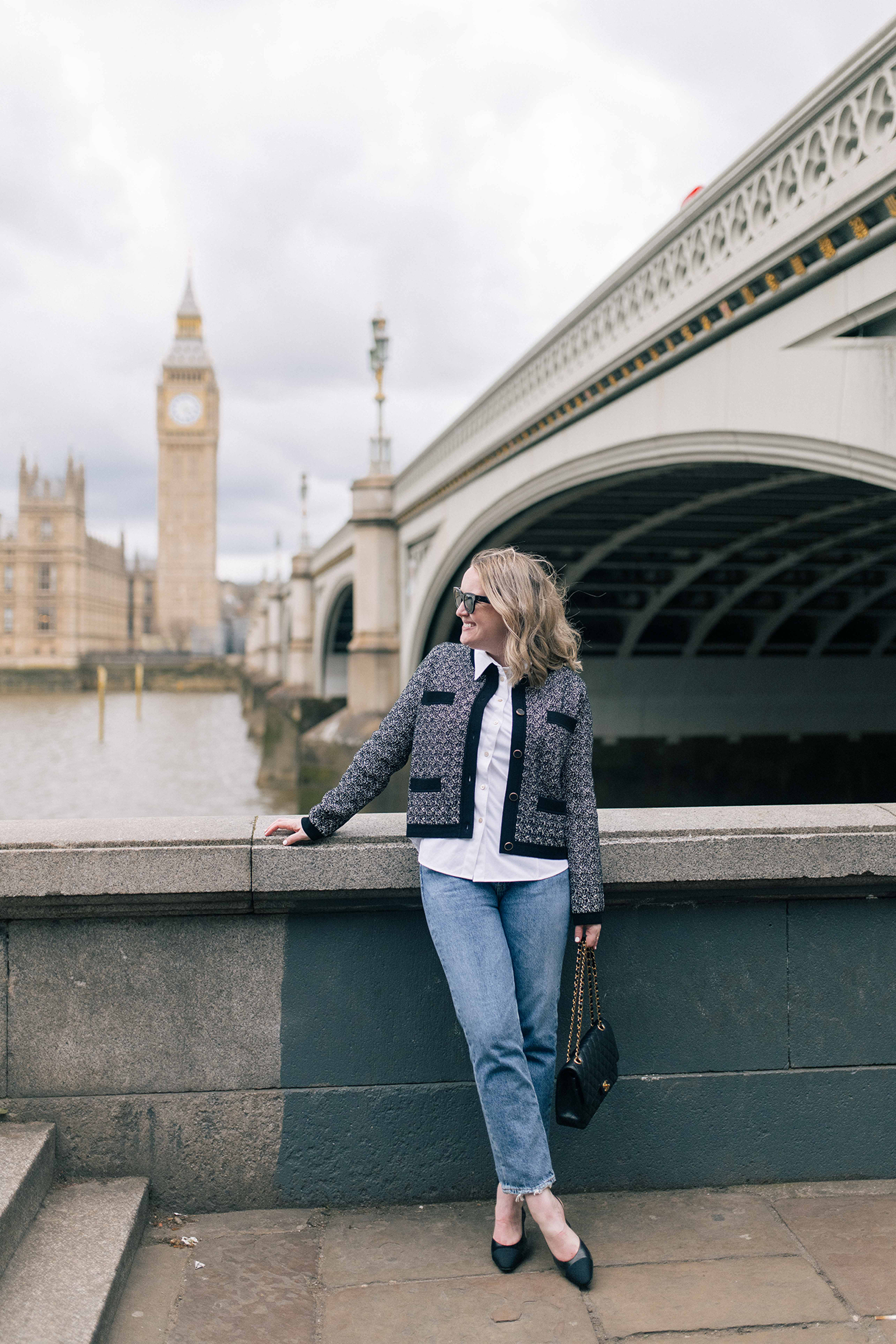 Meghan Donovan of wit & whimsy wearing jeans and a cardigan in front of Big Ben.