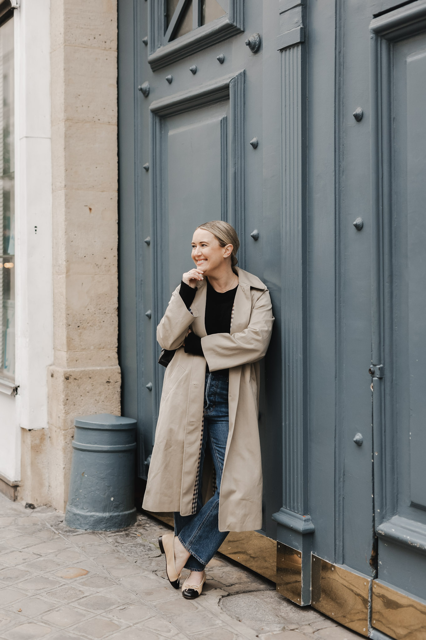 Paris in October Packing List Wit Whimsy wearing a trench coat.